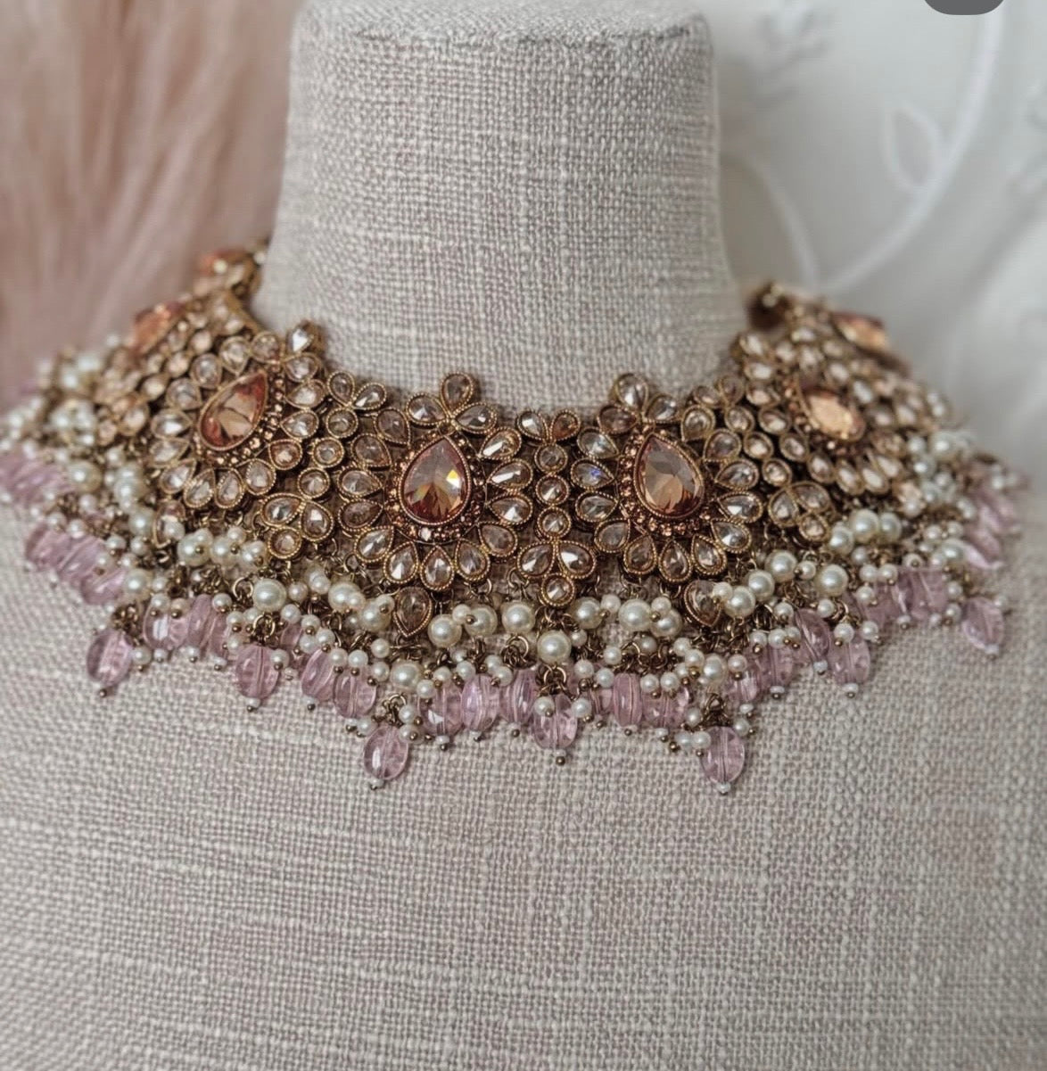 Elegant necklace with pearls and crystals on a mannequin